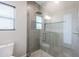 Glass shower features gray tiled walls, rainfall shower head, and built-in shower niche at 34949 N Donald Way, San Tan Valley, AZ 85140