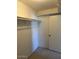 Walk-in closet featuring shelving and a door at 4741 W Annette Cir, Glendale, AZ 85308