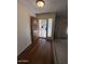 Inviting entryway with wood-look flooring and an attractive front door with security screen at 4741 W Annette Cir, Glendale, AZ 85308