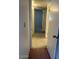 Hallway of home featuring neutral walls and light-colored carpet leading to an open doorway at 4741 W Annette Cir, Glendale, AZ 85308