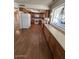 Spacious kitchen with wood floor, white appliances, and a large garden window over the sink at 4741 W Annette Cir, Glendale, AZ 85308
