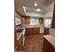 Well lit kitchen features wood flooring, wooden cabinets, and a window over the sink at 4741 W Annette Cir, Glendale, AZ 85308