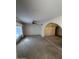 Spacious living room features neutral carpeting, a ceiling fan, and an arched doorway at 4741 W Annette Cir, Glendale, AZ 85308