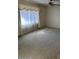 Sunlit living room featuring neutral carpeting and large windows with sheer curtains at 4741 W Annette Cir, Glendale, AZ 85308