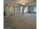 Large living room with neutral carpeting, a mirrored closet, and arched doorways at 4741 W Annette Cir, Glendale, AZ 85308
