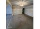 Open living room with neutral carpet, a decorative chandelier, and arched entryways at 4741 W Annette Cir, Glendale, AZ 85308