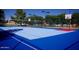 A multi-purpose court featuring basketball hoops and volleyball net for community enjoyment at 4741 W Annette Cir, Glendale, AZ 85308