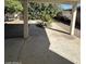 Covered patio area featuring concrete flooring and landscaped backyard views at 4741 W Annette Cir, Glendale, AZ 85308