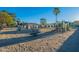A playground covered with sand features swings, a slide, and various play structures, all bathed in sunlight at 4741 W Annette Cir, Glendale, AZ 85308