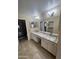 Bathroom features a double sink vanity with granite counters, tile floors, and plenty of natural light at 8444 W Behrend Dr, Peoria, AZ 85382
