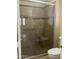 Bathroom showcases a tiled walk-in shower with glass doors, a built-in bench, and a grab bar at 8444 W Behrend Dr, Peoria, AZ 85382