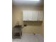 Laundry room equipped with a stainless steel sink and white cabinets at 8444 W Behrend Dr, Peoria, AZ 85382