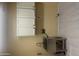 Laundry room equipped with a stainless steel sink and white cabinets at 8444 W Behrend Dr, Peoria, AZ 85382