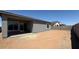 View of the backyard with a block wall, patio, and desert landscaping at 11429 E Utah Ave, Mesa, AZ 85212