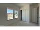 Bedroom with two windows, closet with sliding doors, showing a clean and ready-to-customize space at 11429 E Utah Ave, Mesa, AZ 85212