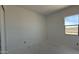 A bedroom with a bright window, smooth walls ready for paint or wallpaper and great natural lighting at 11429 E Utah Ave, Mesa, AZ 85212