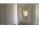 Bright hallway with smooth, freshly painted white walls in a new construction home awaiting final touches at 11429 E Utah Ave, Mesa, AZ 85212