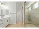 Modern bathroom with stylish vanity, a shower, and a glass-enclosed shower at 23724 N 165Th Dr, Surprise, AZ 85387