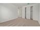 Bedroom with neutral carpet, closet, and white walls for a clean, minimalist aesthetic at 23724 N 165Th Dr, Surprise, AZ 85387