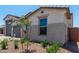 Charming home exterior featuring neutral stucco, a tiled roof, and a beautifully landscaped yard at 23724 N 165Th Dr, Surprise, AZ 85387