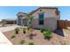 Well-manicured front yard, complemented by a charming home exterior and a tiled roof at 23724 N 165Th Dr, Surprise, AZ 85387