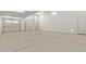 Spacious two-car garage with white walls and a large door providing ample parking and storage at 23724 N 165Th Dr, Surprise, AZ 85387