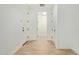 Long, bright hallway with tile flooring and doors leading to various rooms at 23724 N 165Th Dr, Surprise, AZ 85387