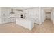 Modern white kitchen features stainless steel appliances, an island, and abundant cabinet space at 23724 N 165Th Dr, Surprise, AZ 85387