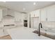 Modern kitchen features stainless steel appliances, quartz countertops, and white cabinets at 23724 N 165Th Dr, Surprise, AZ 85387