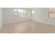 A bright living room features tile flooring, neutral colors, and multiple windows for ample natural light at 23724 N 165Th Dr, Surprise, AZ 85387