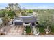 Charming home with modern landscaping, a dark garage door, geometric driveway, and mountain views in the background at 4316 N 86Th Pl, Scottsdale, AZ 85251
