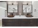 Double sink vanity with decorative mirrors, lighting, and contemporary fixtures at 4316 N 86Th Pl, Scottsdale, AZ 85251