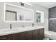Bathroom with dual sinks, a well-lit mirror, and sleek modern fixtures at 4316 N 86Th Pl, Scottsdale, AZ 85251