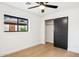 Well-lit bedroom with a ceiling fan, large window, and sliding closet door at 4316 N 86Th Pl, Scottsdale, AZ 85251