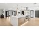 Kitchen with island, stainless steel appliances, pendant lighting, modern cabinetry, and wood floors throughout at 4316 N 86Th Pl, Scottsdale, AZ 85251