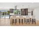 Bright kitchen featuring a large island with pendant lights, modern cabinetry, and backyard views through a large window at 4316 N 86Th Pl, Scottsdale, AZ 85251
