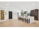 Open-concept kitchen features a large island with seating, pendant lights, wood floors and modern finishes and appliances at 4316 N 86Th Pl, Scottsdale, AZ 85251