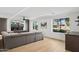 Bright living room with a large sectional sofa, entertainment center with fireplace, accent lighting, and backyard views at 4316 N 86Th Pl, Scottsdale, AZ 85251