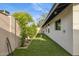 Outdoor putting green with artificial turf and charming landscaping on side of home at 4316 N 86Th Pl, Scottsdale, AZ 85251