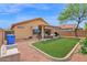 This backyard showcases artificial turf, a covered patio, and a low-maintenance landscape design, blending beauty with practicality at 5424 S 15Th St, Phoenix, AZ 85040