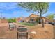 A serene backyard features a cozy seating area, a well-maintained lawn, and mature trees, offering a peaceful outdoor retreat at 5424 S 15Th St, Phoenix, AZ 85040
