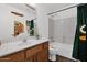 Charming bathroom with single vanity, sports themed decor, and a tub-shower combination at 5424 S 15Th St, Phoenix, AZ 85040