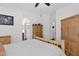 Neutral bedroom with wood furniture, laminate flooring, and ample natural light from nearby windows at 5424 S 15Th St, Phoenix, AZ 85040