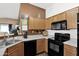 Functional kitchen with oak cabinets, and efficient appliances at 5424 S 15Th St, Phoenix, AZ 85040