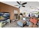 Inviting living room offering a large sectional sofa, ceiling fan, tv, and seamless transition into dining and kitchen area at 5424 S 15Th St, Phoenix, AZ 85040