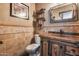 Charming powder room with custom vanity, unique mirror, and rustic accents at 8246 W Melinda Ln, Peoria, AZ 85382