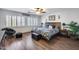 Comfortable bedroom with wood floors, large windows, and decorative furnishings at 8246 W Melinda Ln, Peoria, AZ 85382