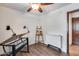 Bedroom with ceiling fan, faux wood floors, a foldable table, and an easel on display at 8246 W Melinda Ln, Peoria, AZ 85382