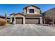 Two-story home with a two-car garage, desert landscaping, and a neutral color palette, set against a bright blue sky at 8246 W Melinda Ln, Peoria, AZ 85382