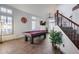 Bright game room features a pool table, staircase with wrought iron railing, and lots of natural light at 8246 W Melinda Ln, Peoria, AZ 85382